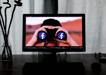 A man looking through binoculars with the Facebook logo over both eyes, just showing that everywhere you look, social media marketing is there! Photo by Glen Carrie on Unsplash